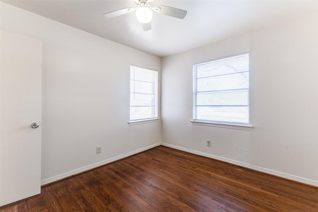 spare room featuring ceiling fan and dark hardwood / wood-style floors