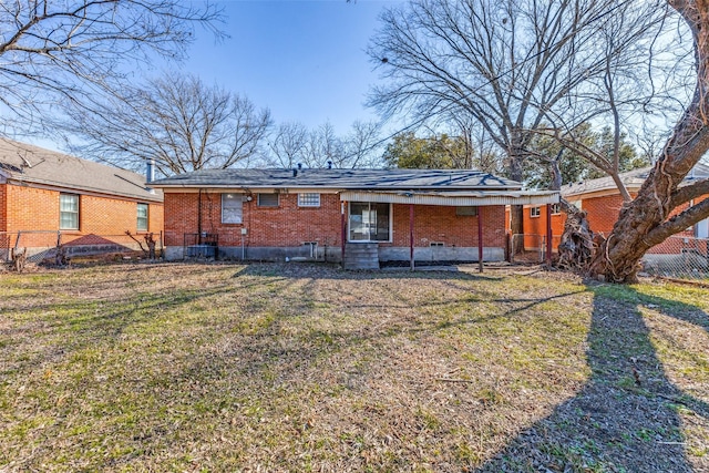 back of property featuring a lawn