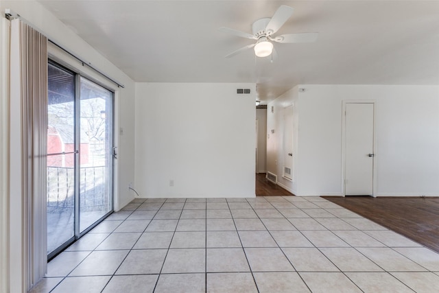 tiled empty room with ceiling fan