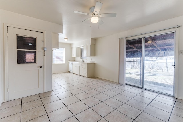 kitchen with ceiling fan, white dishwasher, sink, and light tile patterned floors