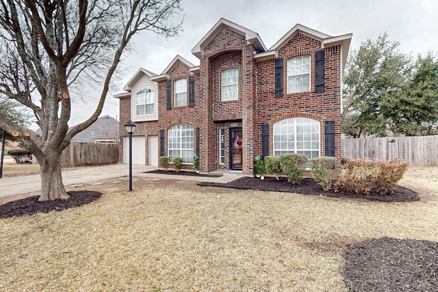 view of property featuring a garage and a front yard