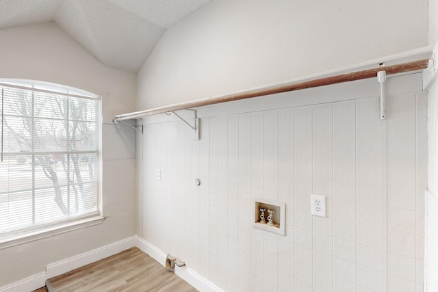 washroom with hardwood / wood-style floors, hookup for a washing machine, and plenty of natural light