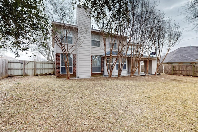 back of house featuring a yard