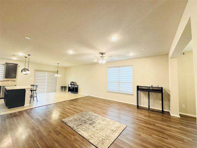 unfurnished living room with hardwood / wood-style flooring and ceiling fan