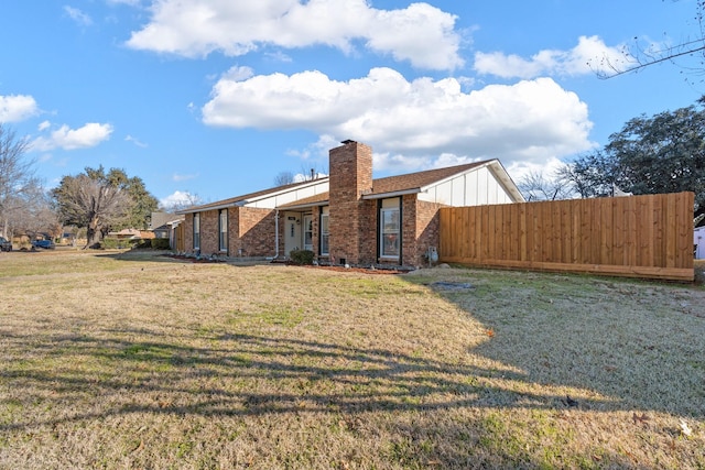 rear view of house with a yard