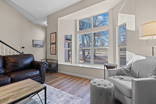 living room featuring vaulted ceiling and light hardwood / wood-style floors