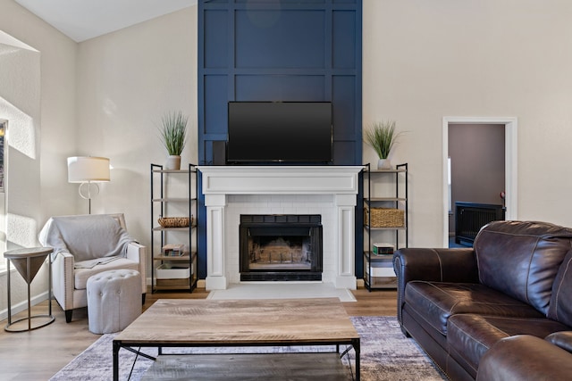 living room featuring lofted ceiling and light wood-type flooring