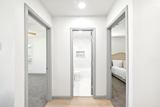 unfurnished bedroom featuring recessed lighting, light wood-type flooring, baseboards, and a closet