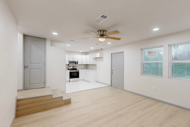 unfurnished living room with baseboards, visible vents, recessed lighting, ceiling fan, and light wood-type flooring