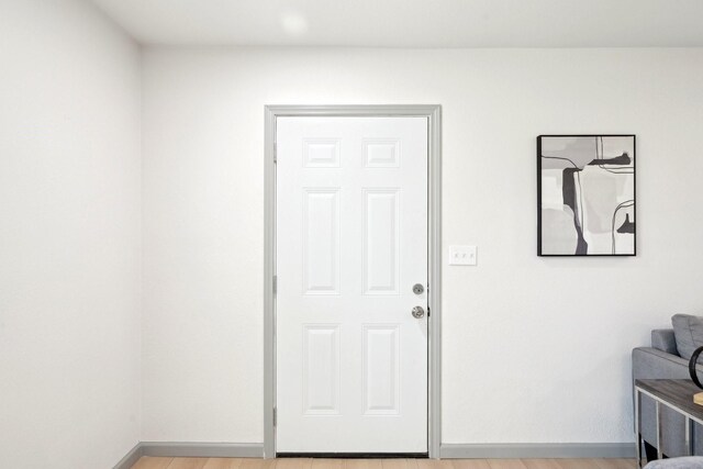 unfurnished room with ceiling fan, a wealth of natural light, and light wood-type flooring