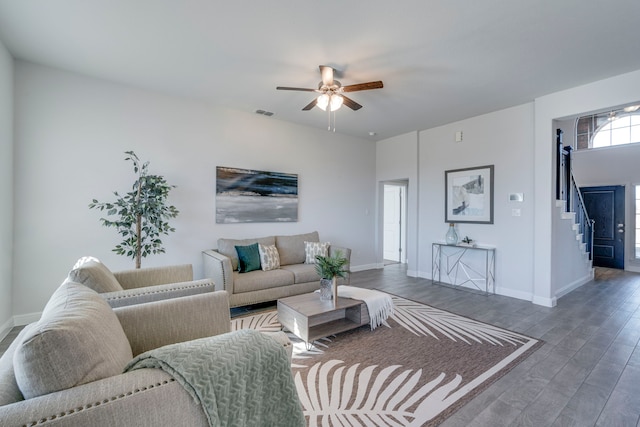 living room with dark hardwood / wood-style floors and ceiling fan