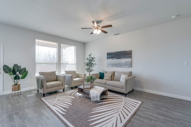 living room with wood-type flooring and ceiling fan