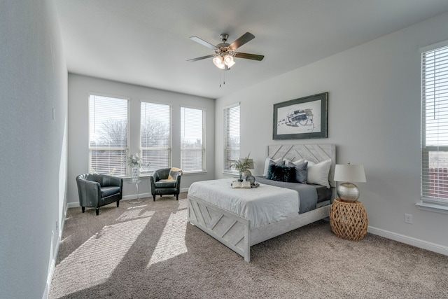 carpeted bedroom with multiple windows and ceiling fan