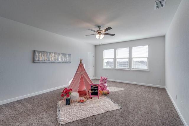 playroom with ceiling fan and carpet flooring