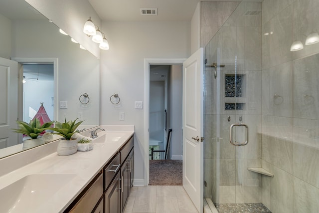 bathroom featuring vanity and a shower with shower door