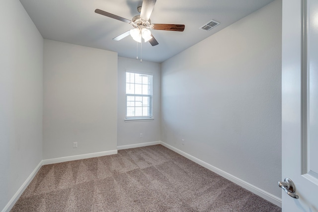 carpeted spare room with ceiling fan