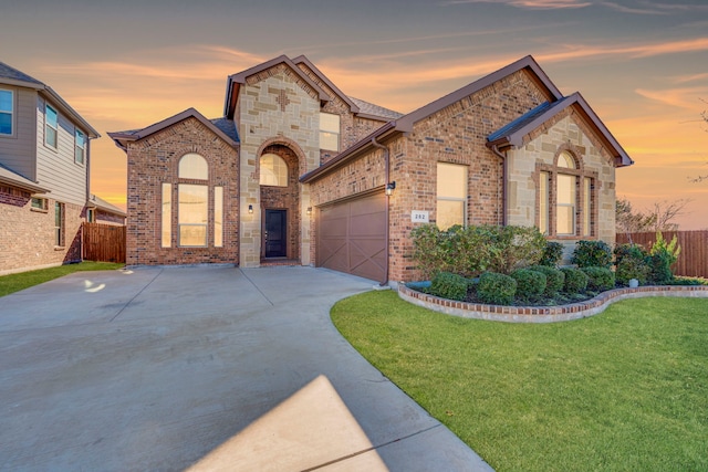 view of front of house with a garage and a lawn