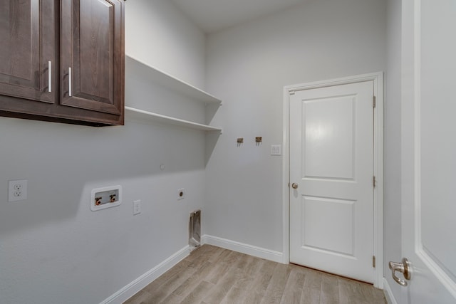 clothes washing area featuring cabinets, hookup for a washing machine, light wood-type flooring, and electric dryer hookup