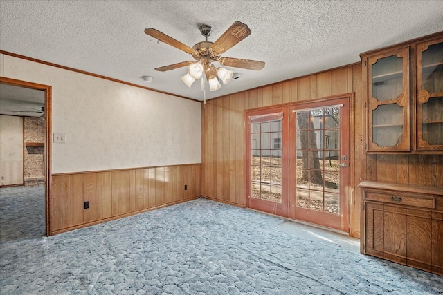 unfurnished room with ceiling fan, light colored carpet, and a textured ceiling