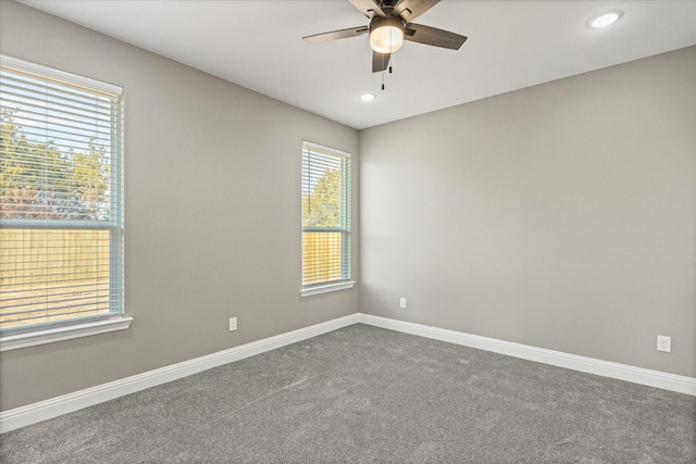 empty room with ceiling fan and carpet flooring