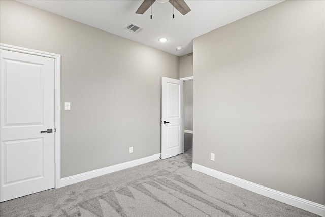 unfurnished bedroom featuring light carpet and ceiling fan