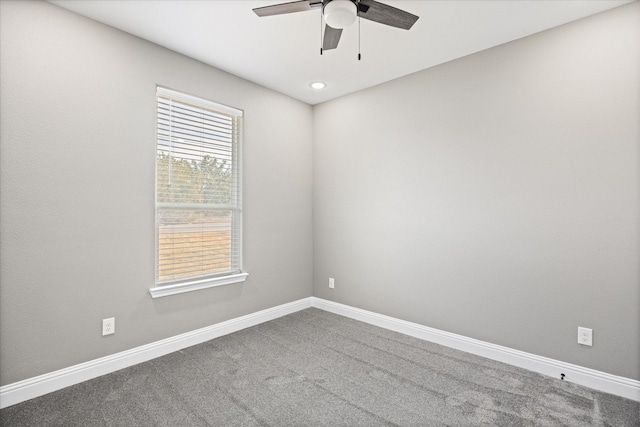 empty room featuring ceiling fan and carpet flooring