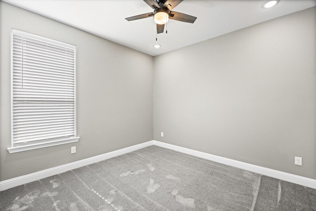 spare room featuring ceiling fan and carpet