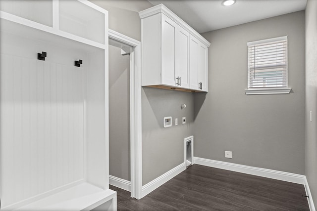 washroom featuring dark hardwood / wood-style flooring, hookup for a gas dryer, cabinets, hookup for a washing machine, and electric dryer hookup