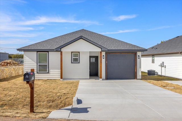 ranch-style home featuring a garage and central AC