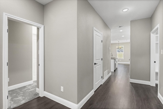 hallway featuring sink and dark hardwood / wood-style flooring