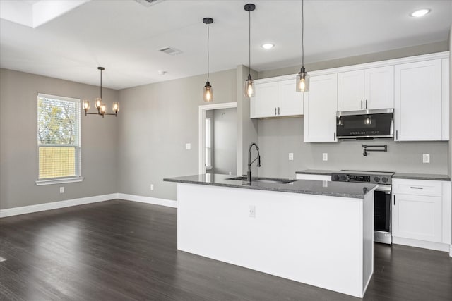 kitchen with a kitchen island with sink, sink, stainless steel appliances, and white cabinets