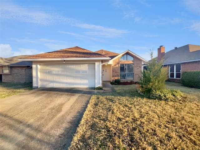 ranch-style home with a garage and a front lawn