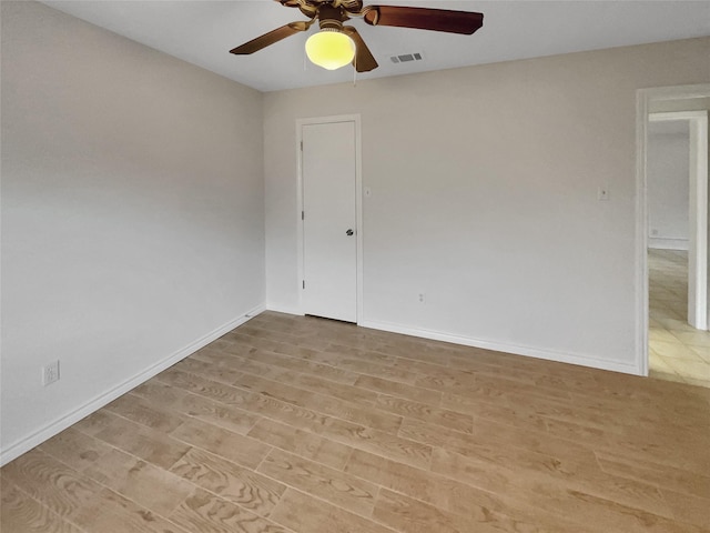 empty room with light hardwood / wood-style floors and ceiling fan