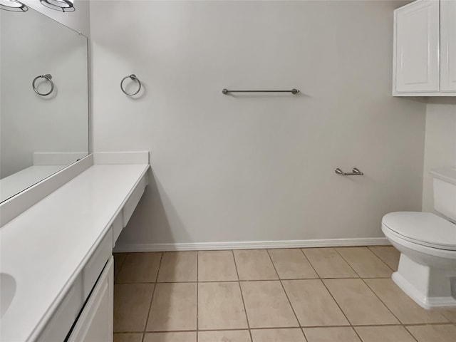 bathroom featuring vanity, tile patterned floors, and toilet