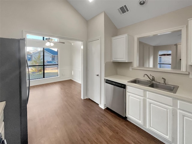 kitchen with lofted ceiling, sink, appliances with stainless steel finishes, dark hardwood / wood-style floors, and white cabinets