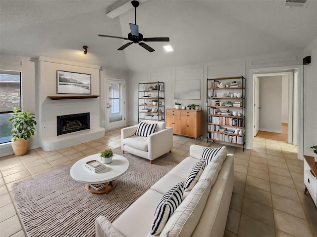 living room featuring a fireplace, light tile patterned floors, a wealth of natural light, and lofted ceiling with beams