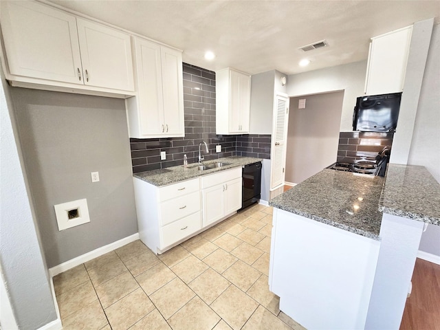 kitchen with black appliances, dark stone counters, and white cabinets