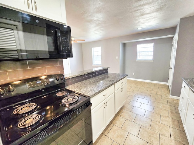 kitchen with light tile patterned floors, white cabinetry, tasteful backsplash, black appliances, and stone countertops