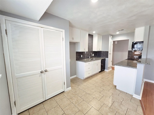 kitchen with sink, backsplash, black dishwasher, white cabinets, and dark stone counters