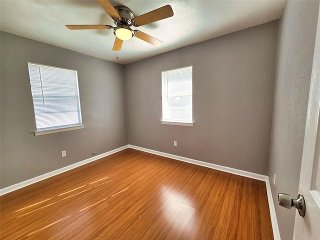 empty room featuring wood-type flooring and ceiling fan