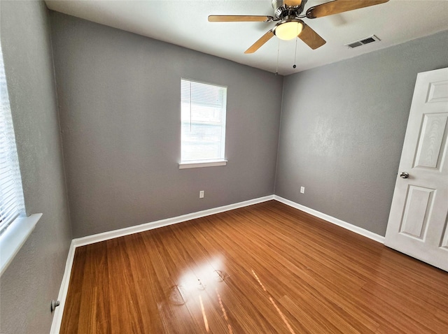 spare room featuring hardwood / wood-style floors and ceiling fan