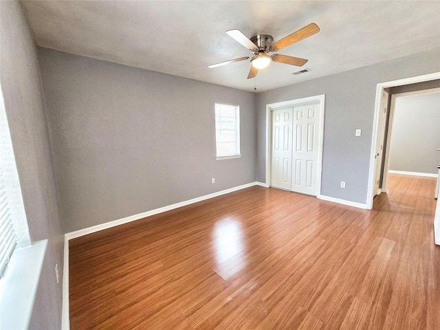 unfurnished bedroom with a closet, ceiling fan, and light hardwood / wood-style floors