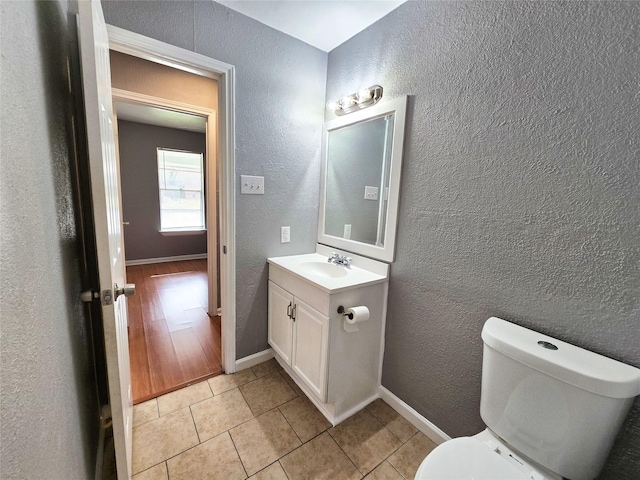 bathroom featuring vanity, toilet, and tile patterned flooring