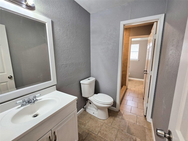 bathroom with vanity, tile patterned floors, and toilet