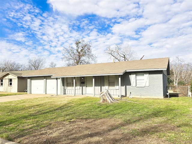 ranch-style home with a garage, a front yard, and covered porch