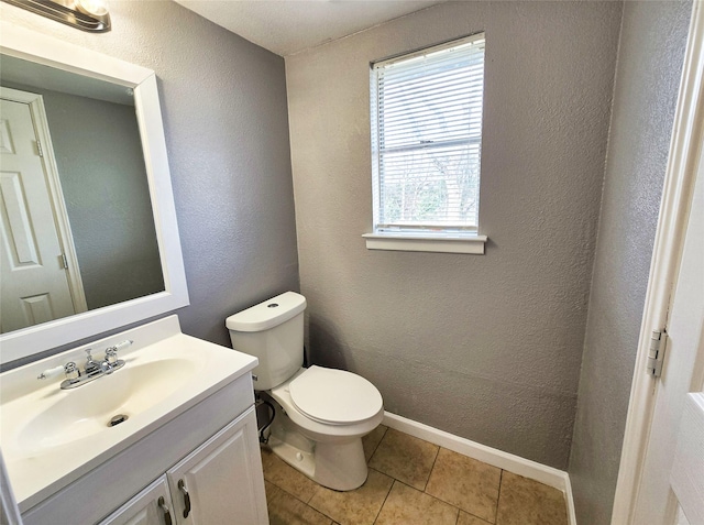 bathroom with vanity, toilet, and tile patterned flooring