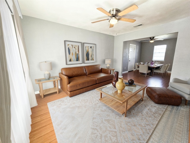 living room with hardwood / wood-style floors and ceiling fan