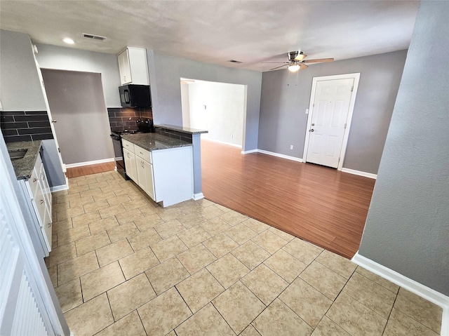 kitchen featuring ceiling fan, tasteful backsplash, black appliances, white cabinets, and kitchen peninsula