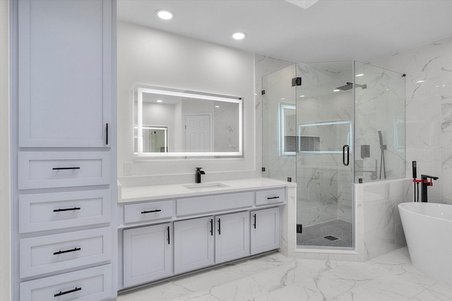 full bath featuring marble finish floor, a marble finish shower, recessed lighting, a soaking tub, and vanity