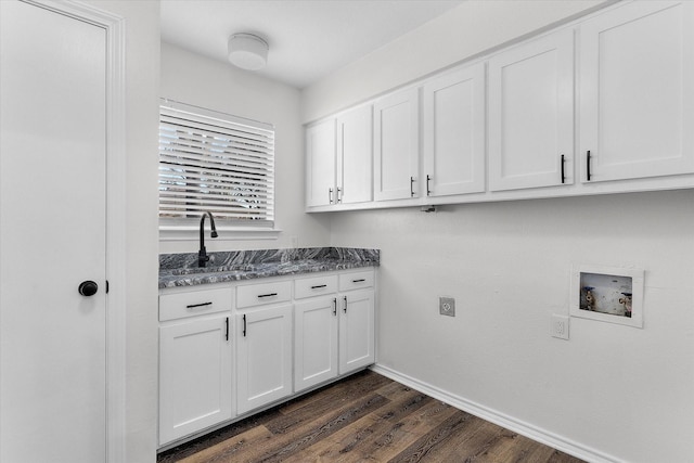 washroom featuring cabinets, sink, washer hookup, and dark hardwood / wood-style flooring